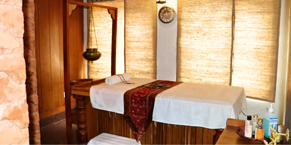Prakriti Vedic Spa — warmly lit massage treatment room